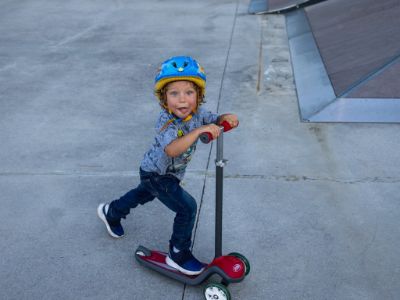 Phoenix Wolf Margera is riding a scooter.